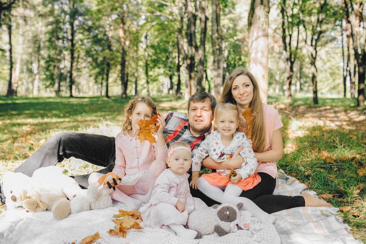 A family seated together outdoors